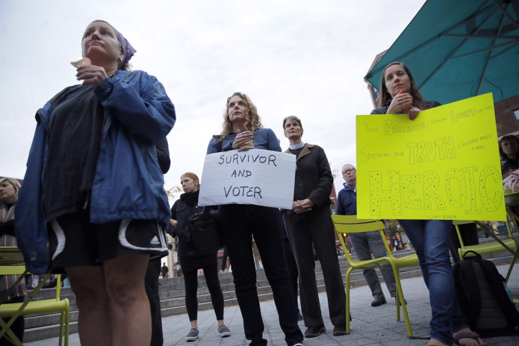 PORTLAND, ME - SEPTEMBER 27: Jennifer Porter, center, of Boston, Massachusetts, holds a sign during a candlelight vigil on Thursday in Congress Square Park. The vigil was held in solidarity with sexual assault survivors and inspired by Christine Blase Ford's decision to testify against Judge Brett Cavanaugh before the Senate Judiciary Committee. Porter said she had been sexually assaulted in high school and college. (Staff photo by Ben McCanna/Staff Photographer)