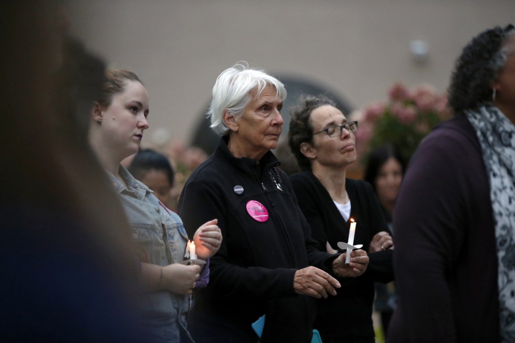 PORTLAND, ME - SEPTEMBER 27: Susan Johnston, center left, of Cape Elizabeth and Claudia Sayre of Kennebunk listen to a one of five speakers at a candlelight vigil on Thursday in Congress Square Park. The vigil was held in solidarity with sexual assault survivors and was inspired by Christine Blase Ford's decision to testify against Judge Brett Cavanaugh before the Senate Judiciary Committee. (Staff photo by Ben McCanna/Staff Photographer)