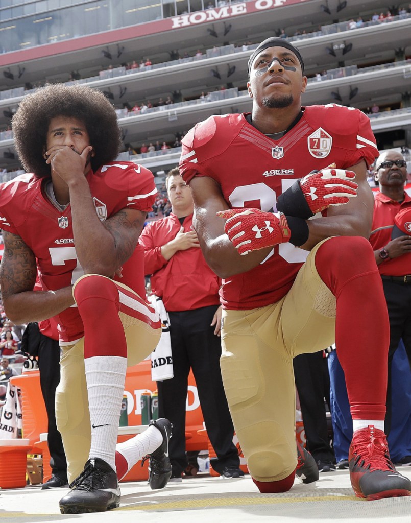 Two years ago, Colin Kaepernick, left, and Eric Reid knelt during the national anthem before a game. Reid went unsigned as a free agent until Thursday.