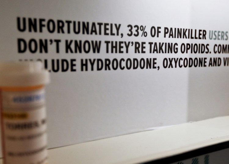 A display representing a medicine cabinet uses data about opioids to inform visitors to a memorial by the National Safety Council in Pittsburgh.