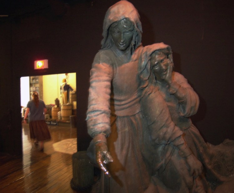 A witch trials memorial statue stands in the Salem Wax Museum of Witches and Seafarers in Salem, Mass. Unlike Salem, a writer says, there are real witches aplenty in the current White House.