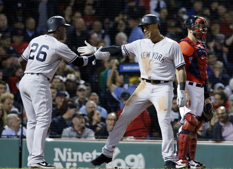 Aaron Hicks of the Yankees celebrates his three-run home run with Andrew McCutchen in front of Red Sox catcher Blake Swihart in the fourth inning Friday night at Fenway Park.
