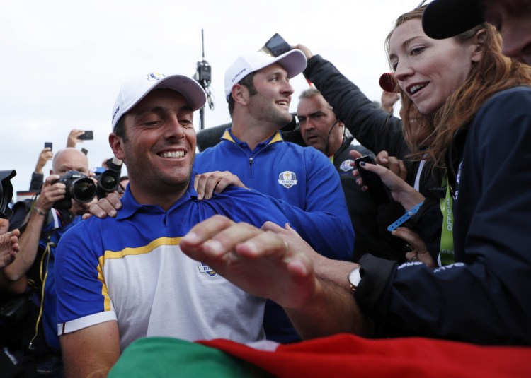 Europe's Francesco Molinari celebrates after winning his singles match to clinch the victory for Europe on the final day of the 42nd Ryder Cup at Le Golf National in Saint-Quentin-en-Yvelines, outside Paris, France.