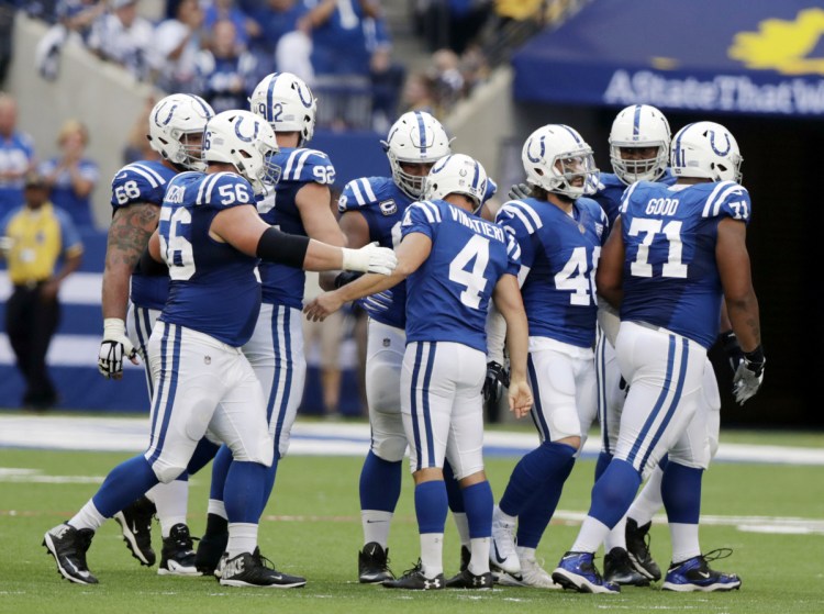 Indianapolis Colts kicker Adam Vinatieri (4) celebrates with teammates after kicking a 42-yard filed goal during the first half  Sunday in Indianapolis. Vinatieri passed Morten Andersen for the most career field goals made in NFL history with the field goal.