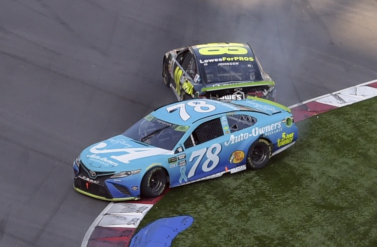 Martin Truex Jr. (78) is hit by Jimmie Johnson (48) in the last lap of the NASCAR Cup series race Sunday at Charlotte Motor Speedway in Concord, N.C.