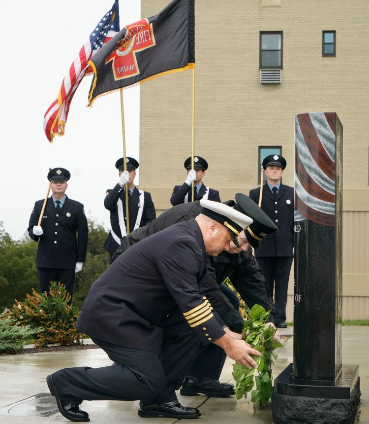 Portland Fire Chief Keith Gautreau, left, and Police Chief Vern Malloch lay wreaths at the base of the 9/11 memorial during a remembrance ceremony Fort Allen Park in Portland on Tuesday. It has been 17 years since the terrorist attacks on New York City, the Pentagon and Flight 93 over Pennsylvania. 