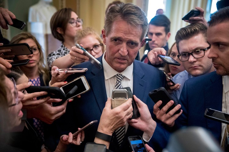 Sen. Jeff Flake, R-Arizona, speaks with reporters after meeting with Senate Majority Leader Mitch McConnell of Kentucky in his office in the Capitol in Washington on Friday. The Senate Judiciary Committee advanced Brett Kavanaugh's nomination for the Supreme Court after agreeing to a late call from Flake for a one week investigation into sexual assault allegations against the high court nominee.