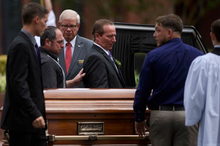 Relatives of Shanann Watts approach her casket before lifting it into a hearse outside Sacred Heart Catholic Church on Saturday in Pinehurst, N.C. A funeral Mass was celebrated for her and her daughters, Bella and Celeste, who were found dead in Colorado on Aug. 16. Chris Watts has been charged with their murders. 
