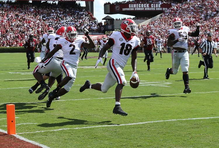Georgia defensive back Deandre Baker returns an interception for a touchdown during the first quarter of the Bulldogs' 41-17 win over South Carolina on Saturday in Columbia, S.C. 