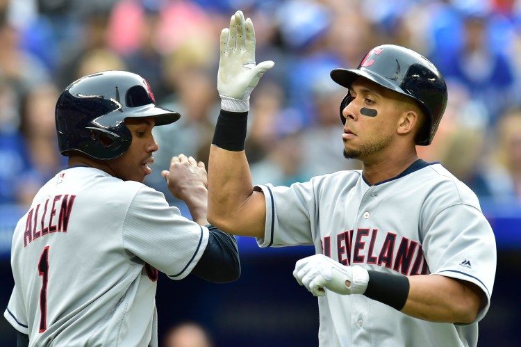 Cleveland Indians Michael Brantley, right, celebrates with Greg Allen after hitting a two-run home run in the fifth inning of the Indians' 9-8 win over Toronto on Saturday in Toronto.