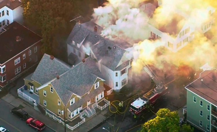 In this image take from video provided by WCVB in Boston, firefighters battle a large structure fire Thursday in Lawrence, Mass. On Friday, Unitil, which provides natural gas to southwestern Maine, said it intends review its systems once the cause of the Massachusetts explosions has been determined.