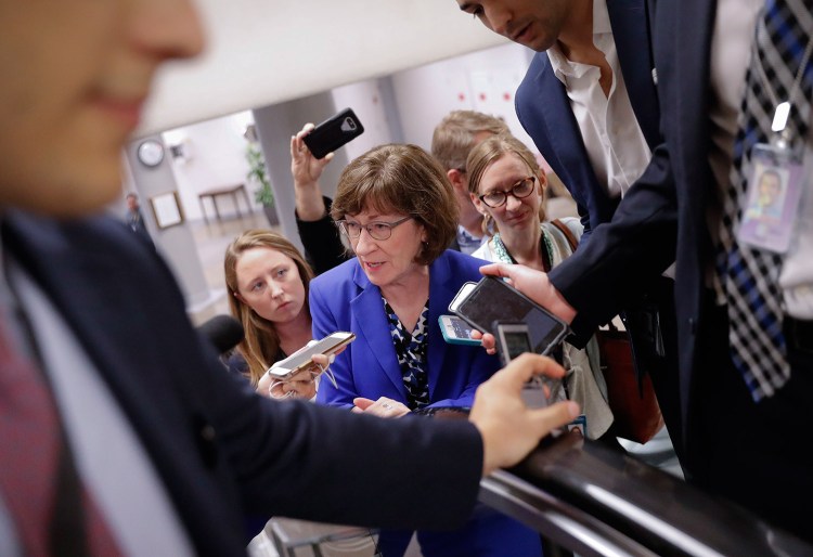 Sen. Susan Collins, R-Maine, speaks to members of the media as she walks to the Senate floor on Capitol Hill in Washington on Monday. When asked about sexual assault allegations against Supreme Court nominee Brett Kavanaugh by a California professor, Collins told reporters that "to be fair to both sides" there needs to be a hearing.