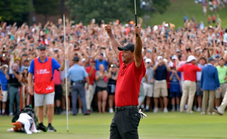 Tiger Woods celebrates after winning the Tour Championship on Sunday in Atlanta. The win was Woods' first since 2013.