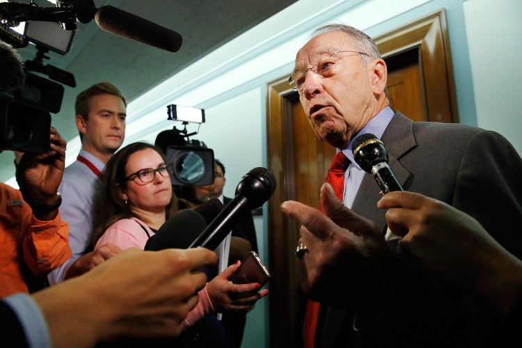 Sen. Chuck Grassley, R-Iowa, right, answers questions from reporters about allegations of sexual misconduct against Supreme Court nominee Brett Kavanaugh on Wednesday as he arrives for a Senate Finance Committee hearing on Capitol Hill in Washington.  