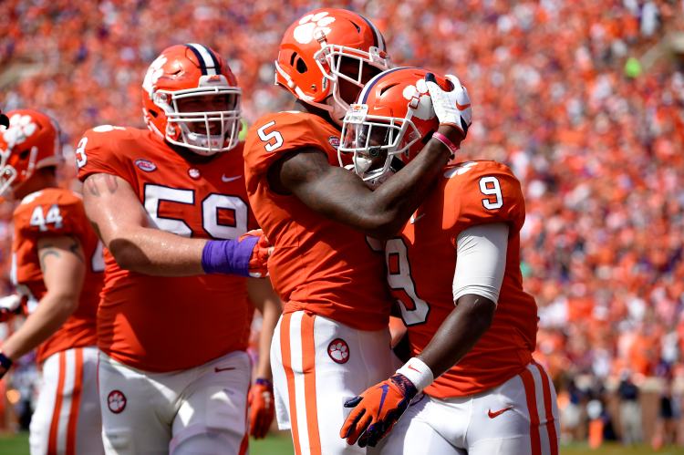 Clemson's Travis Etienne, right, celebrates his touchdown with Tee Higgins, center, and Gage Cervenka during the second half of the TIgers' 27-23 win over Syracuse on Saturday in Clemson, South Carolina.