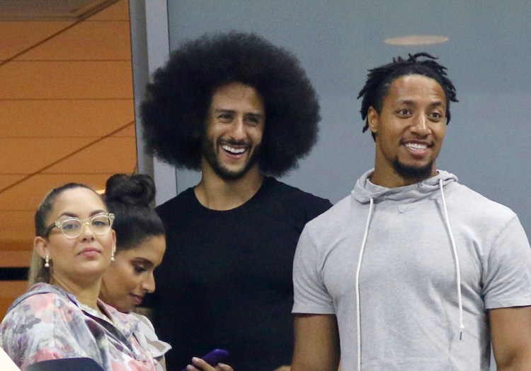 Colin Kaepernick, center, attends the third round of the U.S. Open in New York on Friday. 