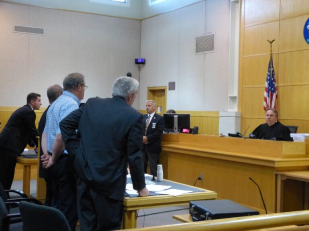 Justice Daniel Billings sentences Robert Welch of Topsham, standing third from left with hands behind his back, to 10 years incarceration and six years of probation, in West Bath District Court on Wednesday. 