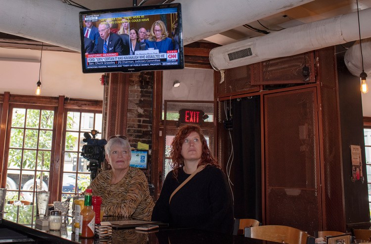Customers watch the testimony of Christine Blasey Ford at Shaw's Tavern on Thursday in Washington, D.C. 