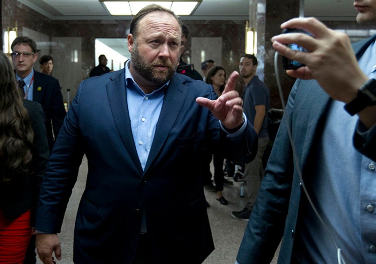 Alex Jones, the right-wing conspiracy theorist, walks the corridors of Capitol Hill after listening to Facebook COO Sheryl Sandberg and Twitter CEO Jack Dorsey testify before the Senate Intelligence Committee .