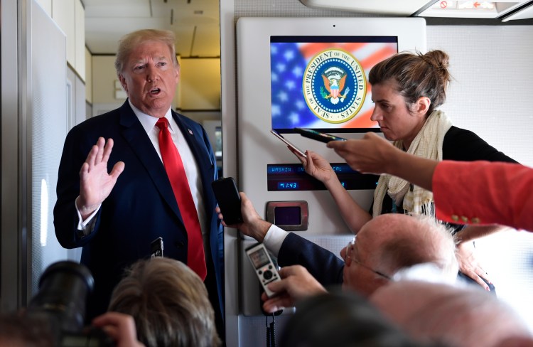 President Trump speaks to reporters on Air Force One on Friday. 
