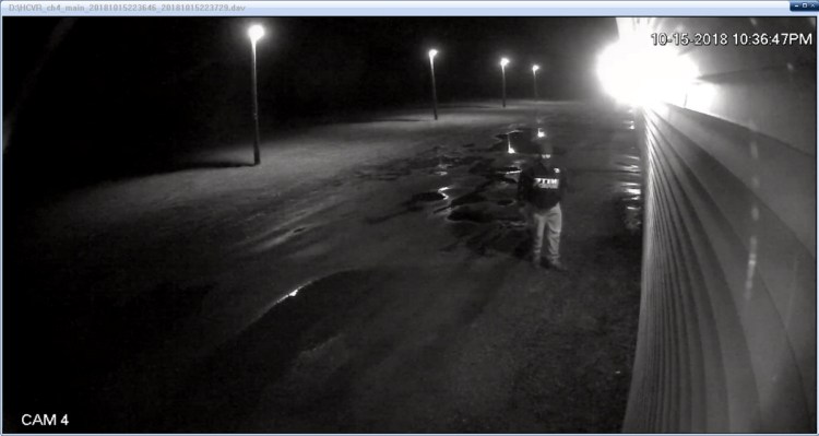 A surveillance camera at R&D Self Storage captured an image of a man wearing a Dale Earnhardt jacket and ski mask who is suspected of arson at the business.