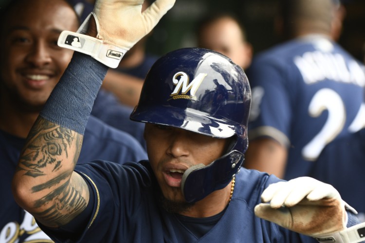 Milwaukee's Orlando Arcia celebrates in the dugout after scoring during the third inning of the Brewers' 3-1 win over the Cubs in the NL Central tiebreaker game on Monday in Chicago.