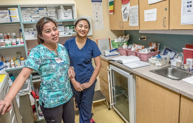 Filipino nurses Janelle Bacani and Christine Tan, both 30, in a medication room at St. Mary's d'Youville Pavilion in Lewiston, joined the staff in a recruiting effort to fill open positions.