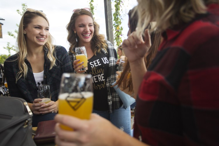 Haeley Stewart, left, of Derry, N.H., celebrates her bachelorette party with Brianna Ledoux of Merrimack, N.H., center, and other friends at the Bissell Brothers taproom at Thompson's Point on Saturday.