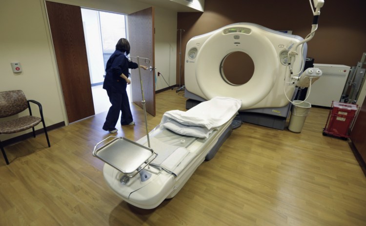 A CT scan technician prepares for a patient at the Silver Cross Emergency Care Center in Homer Glen, Ill. The Trump administration is quietly trying to weaken radiation rules, relying on scientific outliers who argue that a little radiation damage is actually good for you – like a little bit of sunlight. -