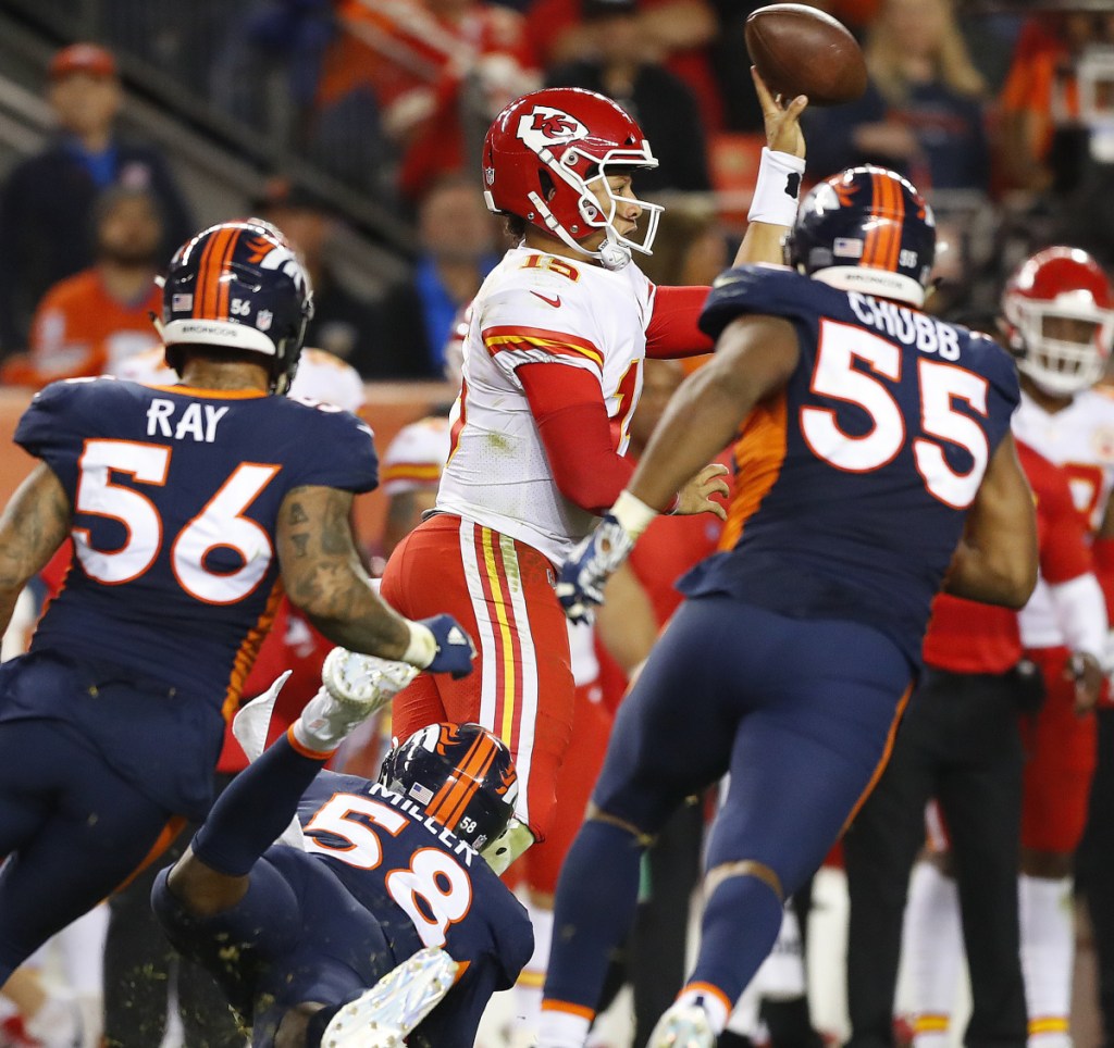 Chiefs quarterback Patrick Mahomes makes a left-handed throw for a first down late in the fourth quarter to help Kansas City to a 27-23 win over the Denver Broncos on Monday night.