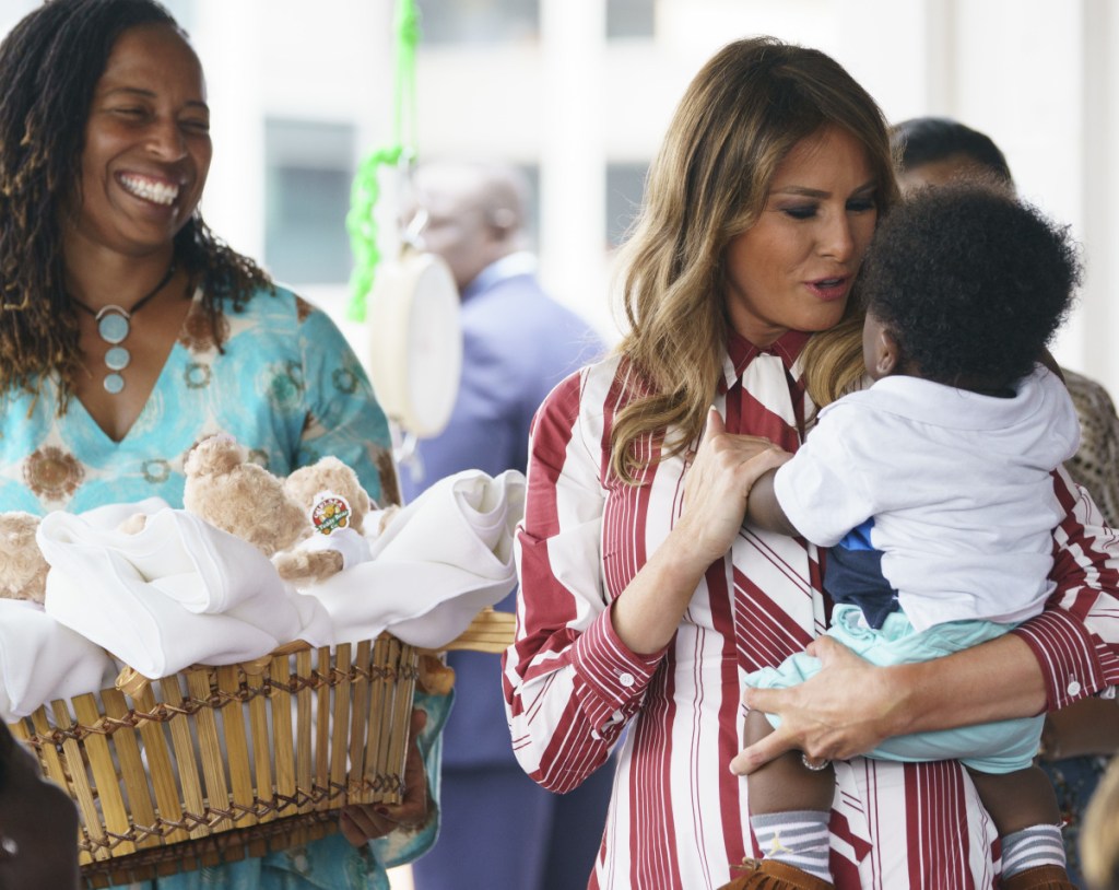 First lady Melania Trump holds a baby as she visits Greater Accra Regional Hospital in Accra, Ghana, on Tuesday. She's also going to Kenya, Malawi and Egypt.