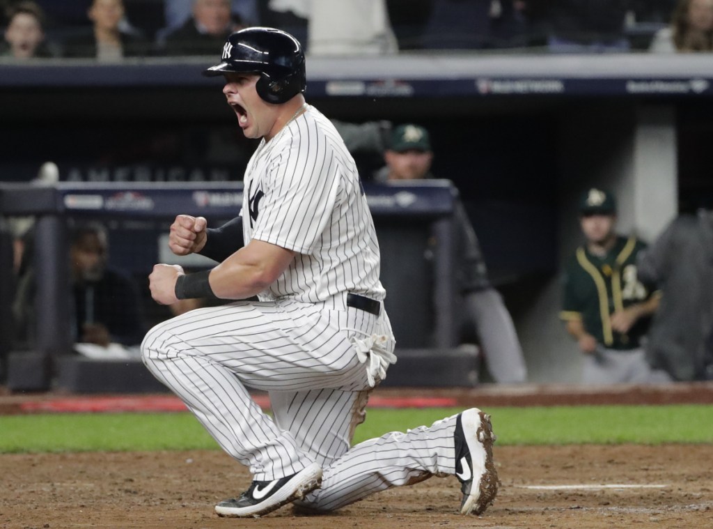 New York's Luke Voit reacts after scoring on a sacrifice fly by Didi Gregorius against the Oakland Athletics in the sixth inning of the American League wild-card game Wednesday.