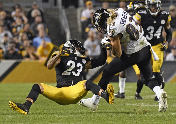 Steelers cornerback Joe Haden, left, stumbles as he tries to tackle Baltimore receiver Willie Snead. Pittsburgh's defense as a whole has also slipped, ranking in the bottom third in the league.