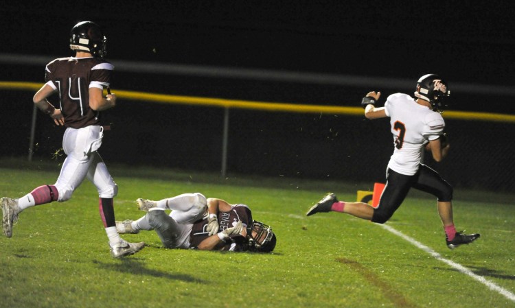 Biddeford's Scott Kelly evades the diving tackle attempt by Greely's Jackson Williams to score a touchdown in the first quarter Friday night.