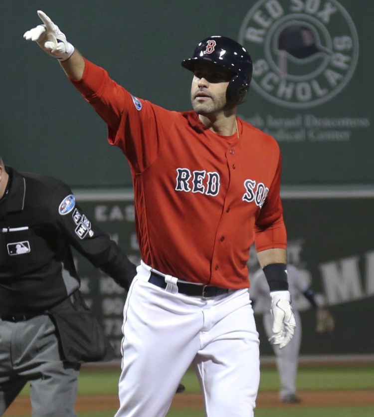 Boston's J.D. Martinez celebrates after his three-run home run against the New York Yankees in the first inning Friday night at Fenway Park.