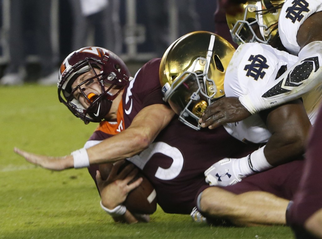 Virginia Tech quarterback Ryan Willis is slammed to the ground on third down near the goal line during the first half Saturday night in Blacksburg, Va. The No. 6-ranked Fighting Irish broke the game open in the second half.
