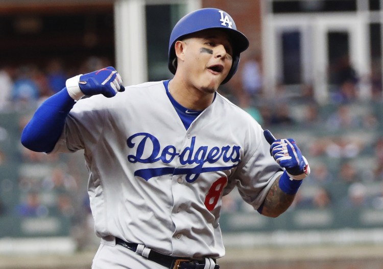 Manny Machado celebrates his three-run homer during the Dodgers' 6-2 win over the Braves in Game 4 of their National League Division Series on Monday in Atlanta. The Dodgers won the series 3-1 to advance to the NLCS.