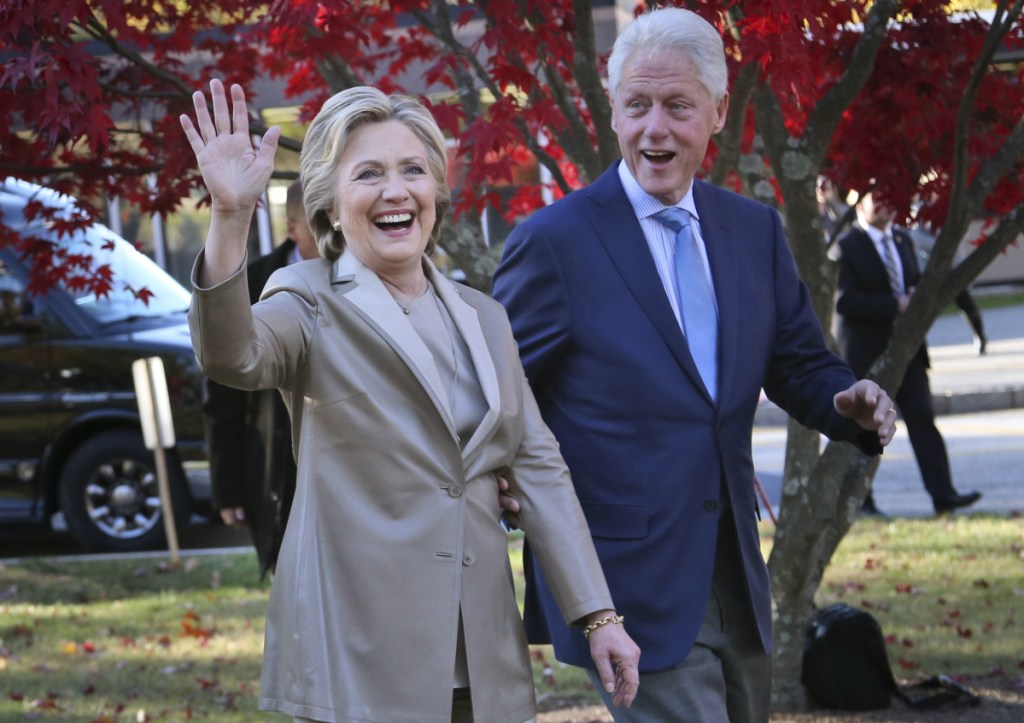 Hillary Clinton and her husband, former President Bill Clinton, greet supporters after voting in Chappaqua, N.Y., on Nov. 8, 2016.
