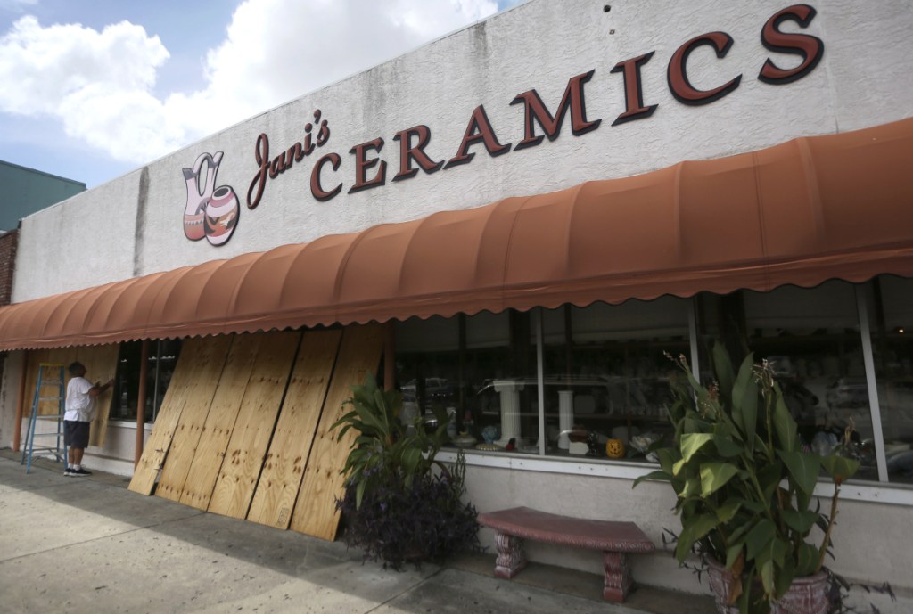 Bobby Smith boards up the windows at Jani's Ceramics in Panama City, Fla., on Monday in preparation for the arrival of Hurricane Michael. (Patti Blake/News Herald via AP)
