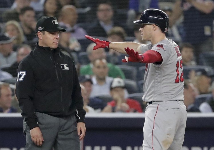 Brock Holt celebrates at third base after a two-run triple in the fourth inning Monday in New York. Holt hit for the cycle and drove in five run as Boston beat New York 16-1 to take a 2-1 lead in their American League Division Series.