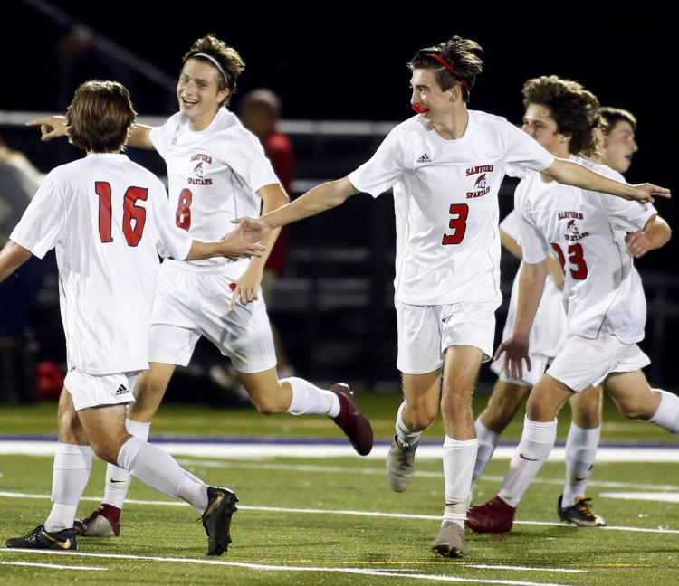 Sanford players celebrate their second goal, scored by Alex Kirven, second from left, in the second half of Tuesday's win.