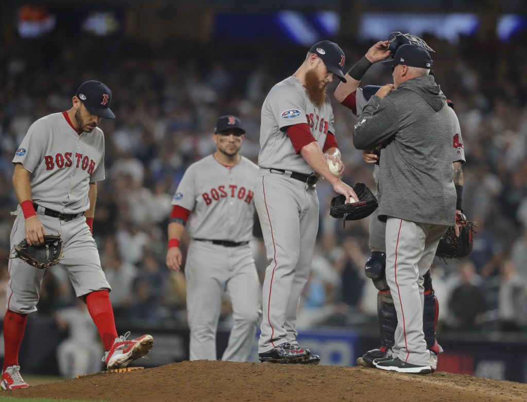 Boston Red Sox relief pitcher Craig Kimbrel talks with pitching coach Dana LeVangie during the ninth inning Tuesday night at Yankee Stadium in New York. (AP Photo/Julie Jacobson)