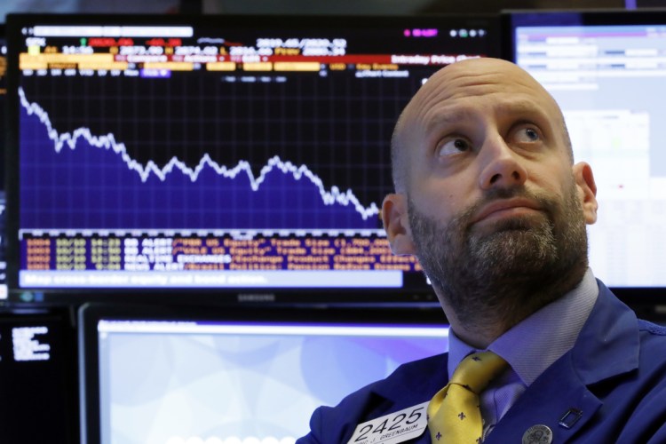 Specialist Meric Greenbaum works at his post on the floor of the New York Stock Exchange on Wednesday.