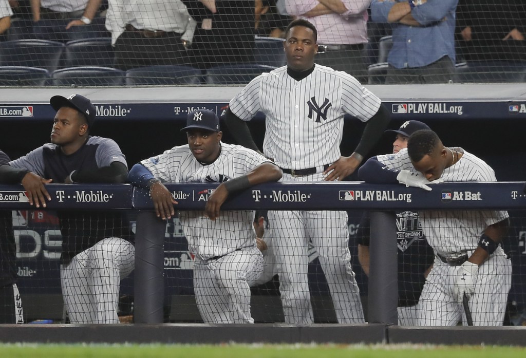 The Yankees watch from the dugout during the ninth inning of Game 4 of the ALDS against the Boston Red Sox on Tuesday.
