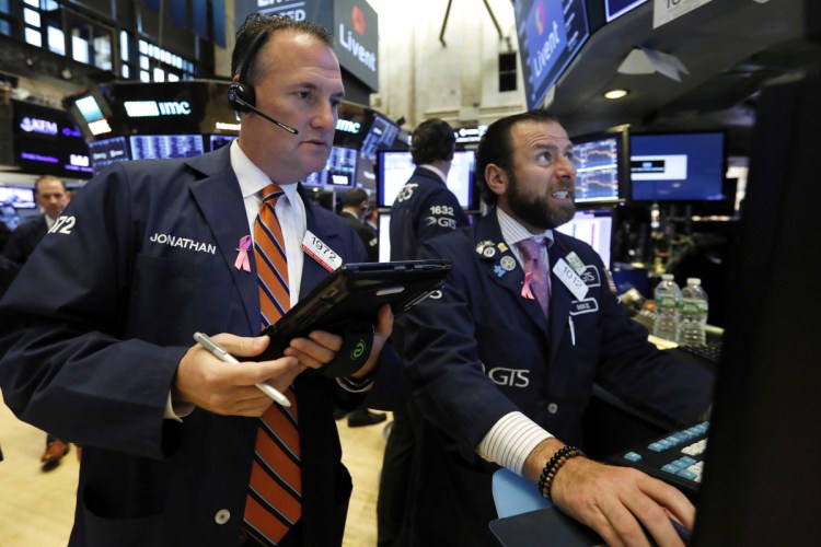 Trader Jonathan Corpina, left, and specialist Michael Pistillo work on the floor of the New York Stock Exchange on Thursday. The Dow Jones industrial average ended the day down 2.1 percent, or 546 points, to 25,052. It pushed the two-day loss to nearly 1,400 points.
