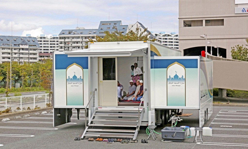 Men pray in a room in the back of the truck. The mobile mosque is equipped with four air conditioners. MUST CREDIT: Japan News-Yomiuri photo