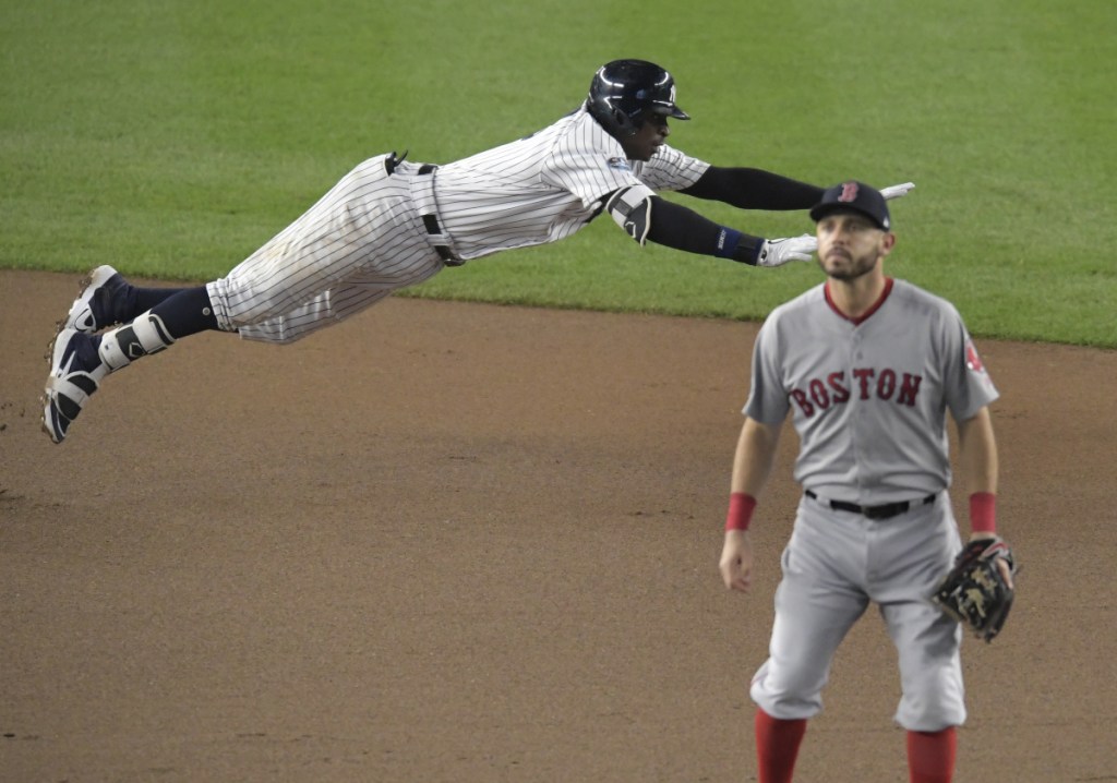 Didi Gregorius of the Yankees dives into second base after hitting a double against Boston in the ALDS on Tuesday. Gregorius needs Tommy John surgery.