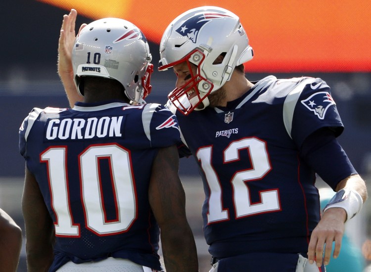 Josh Gordon, left, is continuing to learn the playbook, and it doesn't hurt that his locker is right next to Tom Brady's. Since his trade from Cleveland, Gordon has four catches for 82 yards and a touchdown.