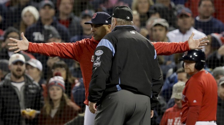 Boston Manager Alex Cora argues a strike three call with umpire Joe West during the fifth inning in Game 1 of a baseball American League Championship Series against the Houston on Saturday in Boston. Cora was thrown out of the game nd Houston went on to win Game 1.