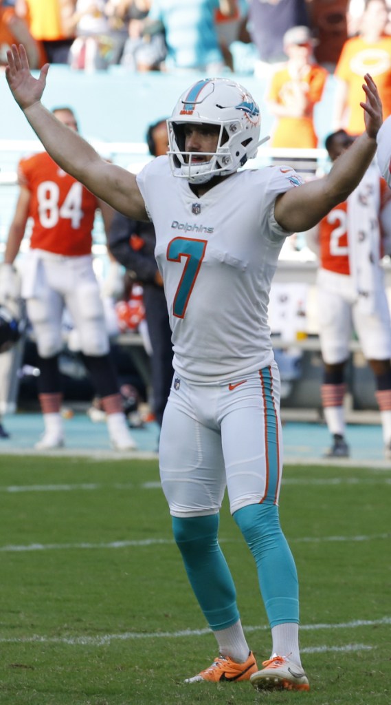 Jason Sanders of the Miami Dolphins raises his arms Sunday after hitting the 47-yard field goal on the final play of overtime that provided a 31-28 victory against the Chicago Bears.